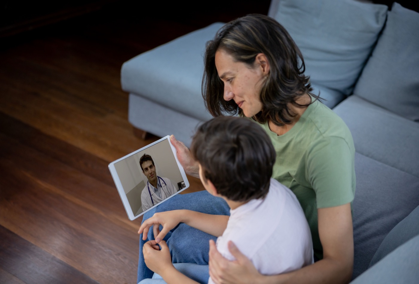 Mother and son on a telehealth video visit with a doctor